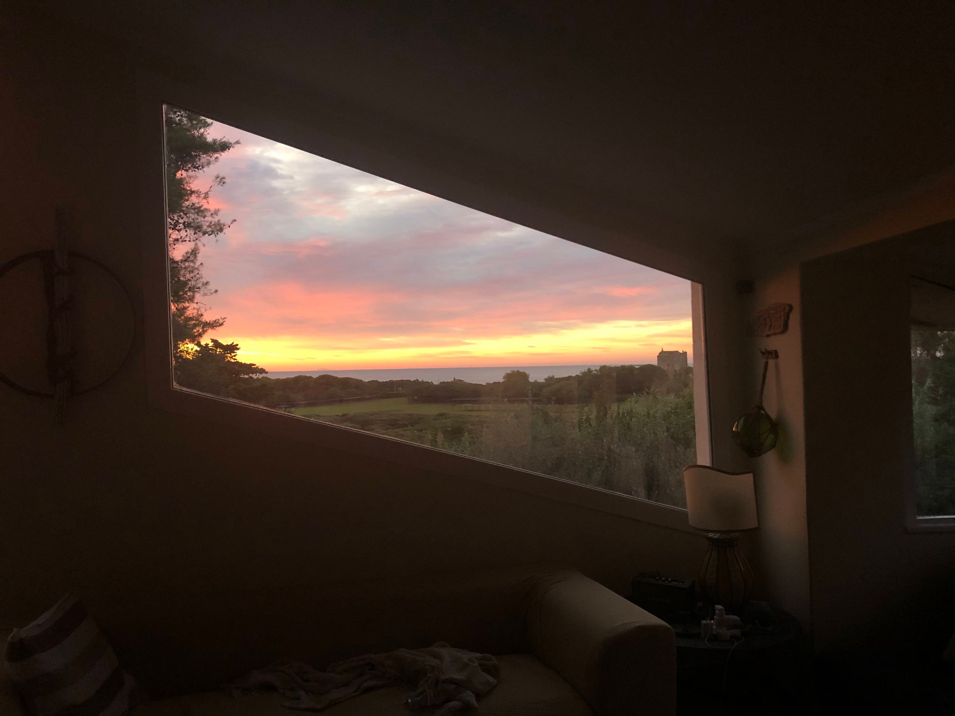 Sunset seen through the trapezoid living-room window