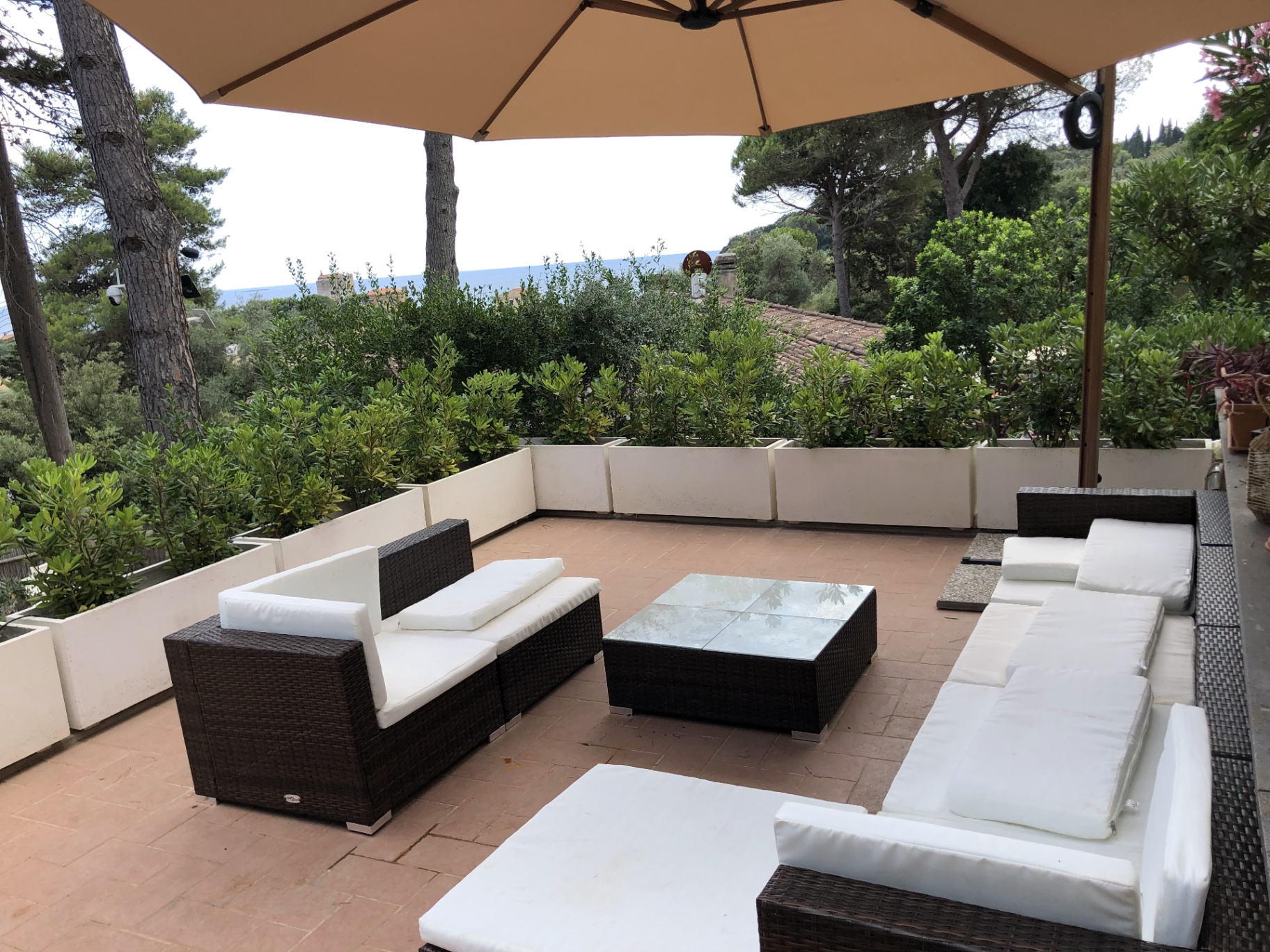 Upper terrace lounge with a glimpse of the sea